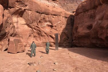 epa08839413 A handout photo made available by the Utah Department of Public Safety (DPS) shows wildlife officials inspecting a monolith discovered in southeastern Utah, USA, 18 November 2020 (issued 24 November 2020). According to a statement by DPS, Utah officials have discovered a monolith of unknown origin in the wild. EPA/Utah Department of Public Safety HANDOUT HANDOUT EDITORIAL USE ONLY/NO SALES