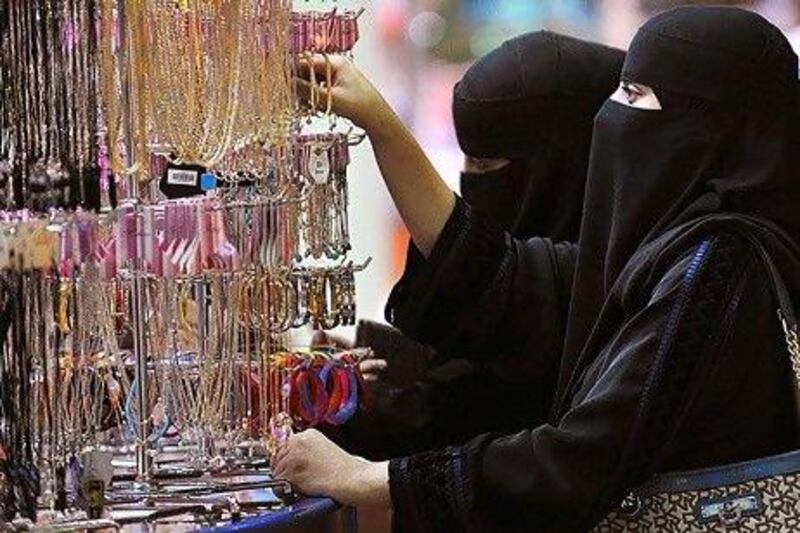 The cash withdrawal levels were high by global standards and a good indicator of the Saudi consumer boom. Above, Saudi women shop at a mall in Riyadh. Fayez Nureldine / AFP