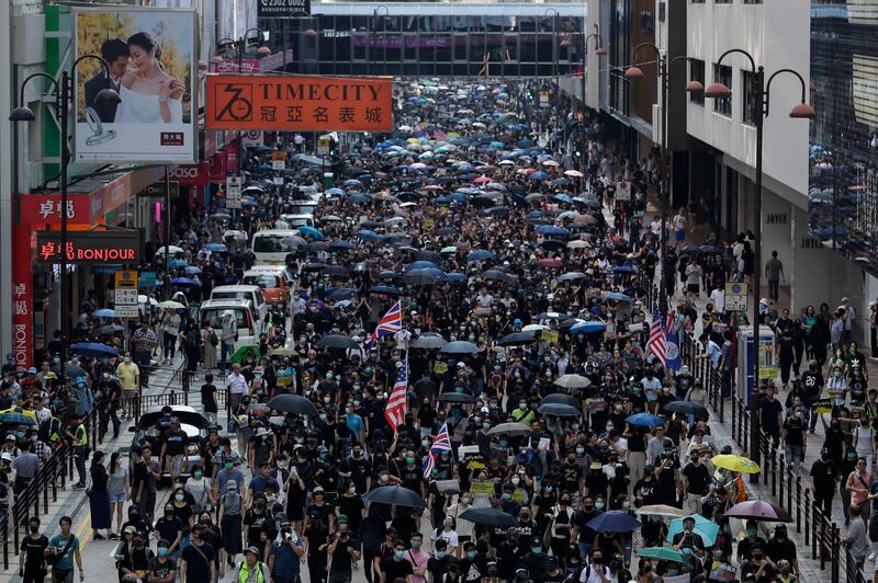 Thousands of protesters march during a rally in Hong Kong, Sunday, Oct. 20, 2019. Hong Kong protesters again flooded streets on Sunday, ignoring a police ban on the rally and demanding the government meet their demands for accountability and political rights. (AP Photo/Mark Schiefelbein)