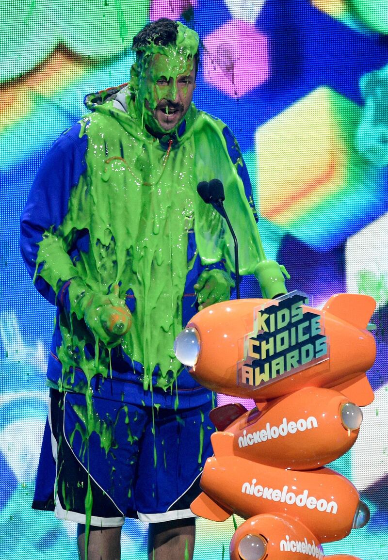 Adam Sandler gets slimed as he accepts the award for favourite male voice from an animated movie for 'Hotel Transylvania 3: Summer Vacation'. AP