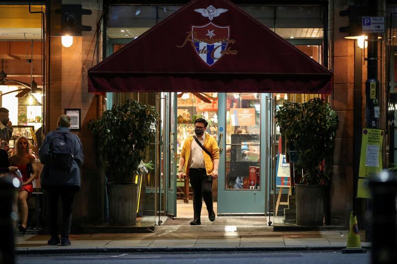 A person leaves a pub amid the coronavirus disease (COVID-19) outbreak, in Manchester, Britain September 24, 2020. REUTERS/Molly Darlington