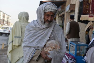 A elderly man walks along a street in Kandahar.  AFP