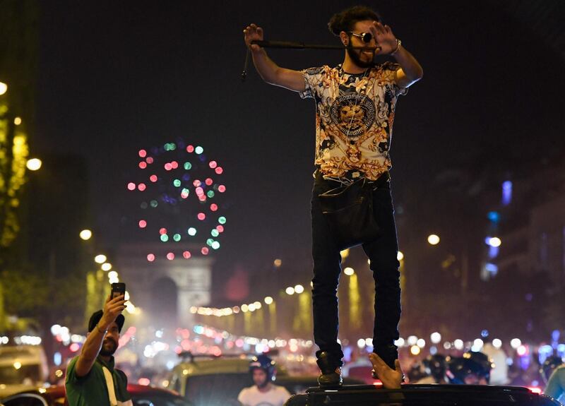 Algeria's supporters celebrate in front of the Arc de Triomphe. AFP