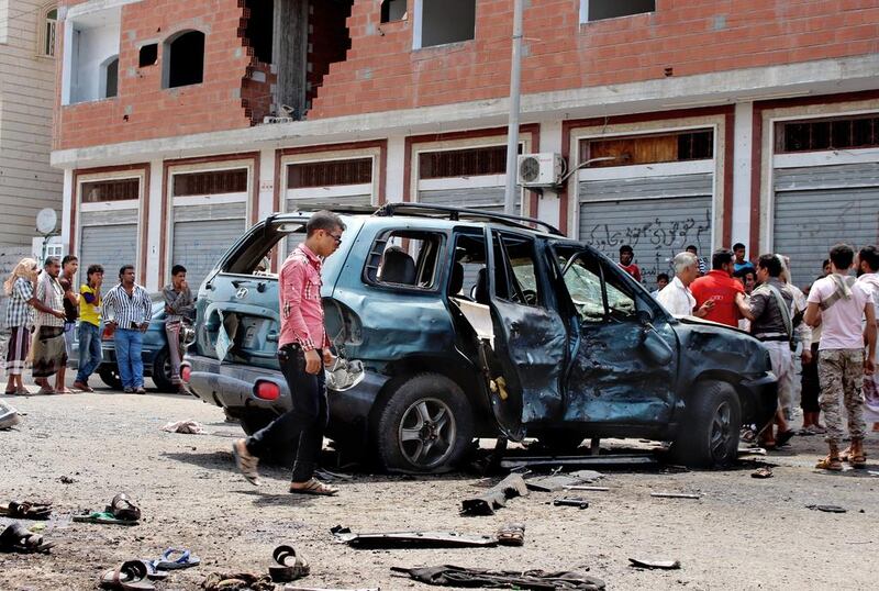 People gather at the scene of twin suicide bombings in Aden on May 23, 2016, that were claimed by ISIL and killed at least 45 people. AP Photo