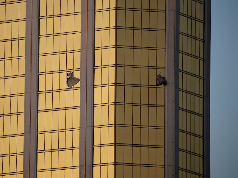 Drapes billow out of broken windows at the Mandalay Bay resort and casino in Las Vegas. John Locher / AP Photo/John Locher