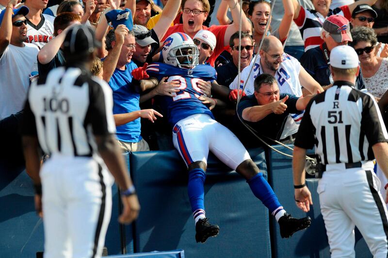 Buffalo Bills cornerback Drayton Florence jumps into the stands to celebrate an interception and touchdown against the New England Patriots in the fourth quarter of their NFL football game in Orchard Park, New York September 25, 2011.    REUTERS/Doug Benz   (UNITED STATES - Tags: SPORT FOOTBALL) *** Local Caption ***  DBS108_NFL-_0925_11.JPG