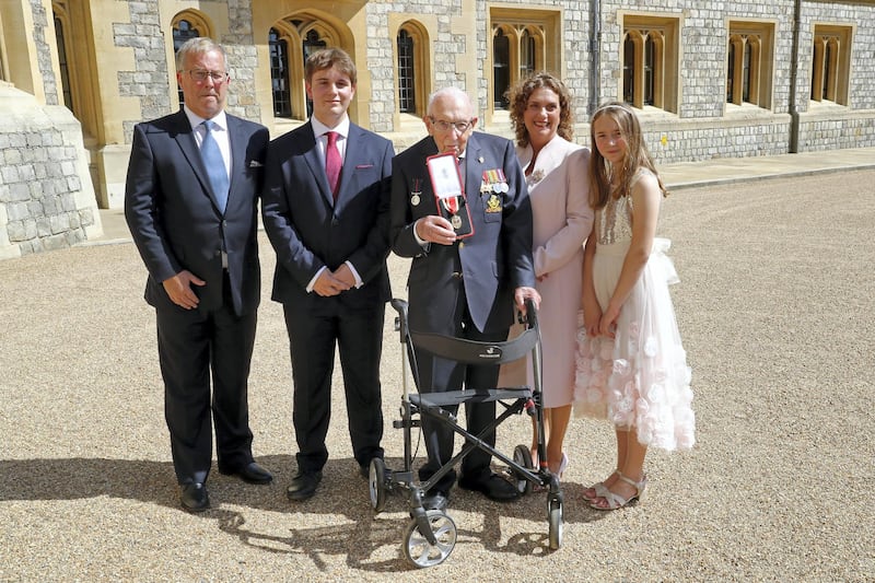 WINDSOR, ENGLAND - JULY 17: Captain Sir Thomas Moore poses with his family after being awarded with the insignia of Knight Bachelor by Queen Elizabeth II at Windsor Castle on July 17, 2020 in Windsor, England. British World War II veteran Captain Tom Moore raised over Â£32 million for the NHS during the coronavirus pandemic.  (Photo by Chris Jackson/Getty Images)