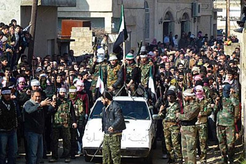 The Syrian president Bashar Al Assad continues his hold on power as the uprising against him continues. On Friday, Syrian soldiers who defected to join the Free Syrian Army participate in a rally against the Al Assad regime in the town of Hula, near Homs.