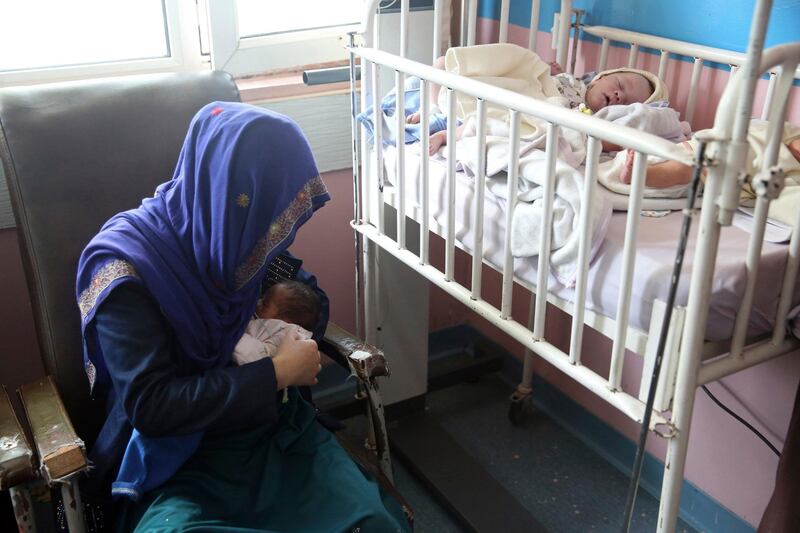 FILE - In this May 13, 2020, file photo, a mother breastfeeds her two-day-old baby at the Ataturk Children's Hospital a day after being rescued from another maternity hospital following a deadly attack, in Kabul, Afghanistan. The United Nations on Sunday, June 21, 2020 released a special report expressing concerns over what it called recent â€œdeliberate attacksâ€ against healthcare workers and facilities in Afghanistan during the COVID-19 pandemic. (AP Photo/Rahmat Gul, File)