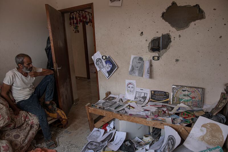 Duniana al-Amour's father, Adnan, in her damaged room, which was hit by an Israeli strike. The young woman was one of the first people killed by Israeli strikes in the latest round of violence. Shrapnel tore through her bedroom during Israel’s surprise opening salvo last Friday. AP