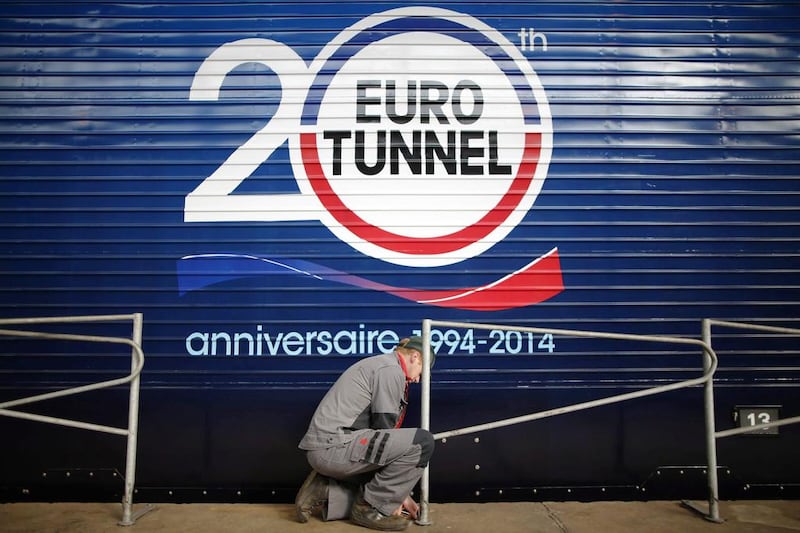 An employee works next to a Eurotunnel freight train at the Channel tunnel maintenance center in Coquelles, near Calais. Christian Hartmann / Reuters