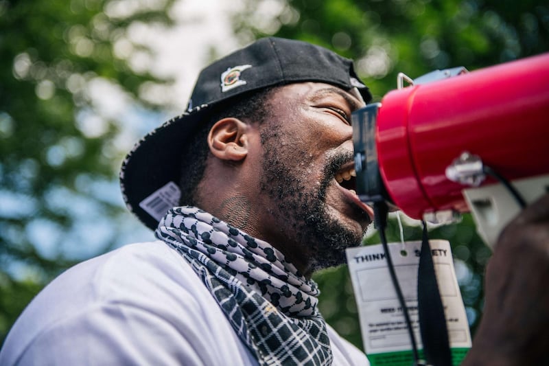 ST PAUL, MN - JUNE 27: A man speaks in a microphone to demonstrators at a Pro-Police rally on June 27, 2020 in St Paul, Minnesota. Bikers for Trump hosted a Back the Blue Pro-Police rally at the Governors Mansion. Residents and Minnesota community members participated by demonstrating opposition to the gathering.   Brandon Bell/Getty Images/AFP
== FOR NEWSPAPERS, INTERNET, TELCOS & TELEVISION USE ONLY ==
