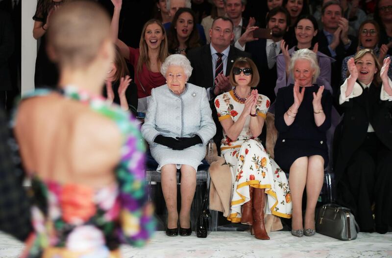 Britain's Queen Elizabeth II, 91, wore black gloves for her first-ever London Fashion Week front row appearance. Reuters