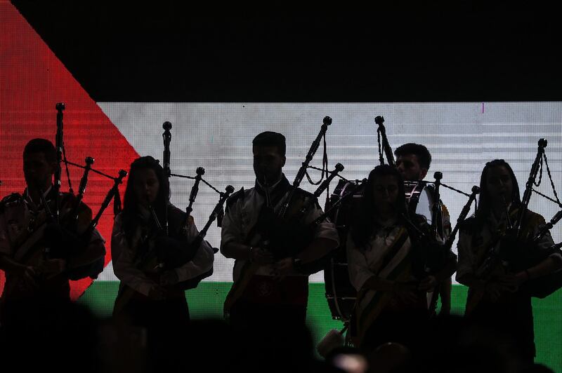 epa08042307 Palestinianss play bagpipes as they attend a ceremony of lighting a Christmas tree in Gaza City, 03 December 2019. The event was organised by the YMCA Gaza.  EPA/MOHAMMED SABER