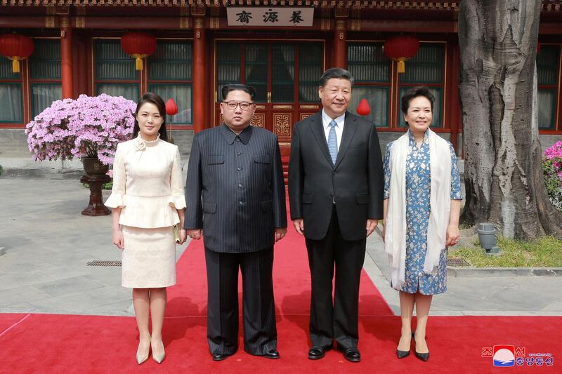 North Korean leader Kim Jong Un and wife Ri Sol Ju, and Chinese President Xi Jinping and wife Peng Liyuan pose for a photo, as Kim Jong Un paid an unofficial visit to Beijing. KCNA / via Reuters