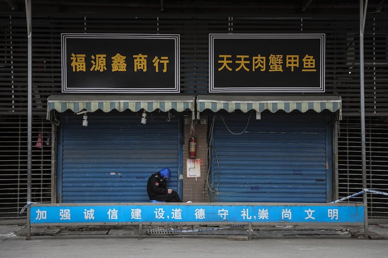 A security guard sits outside the closed Huanan Seafood Wholesale Market, which has been linked to cases of Coronavirus in Wuhan, Hubei province, China. Getty Images