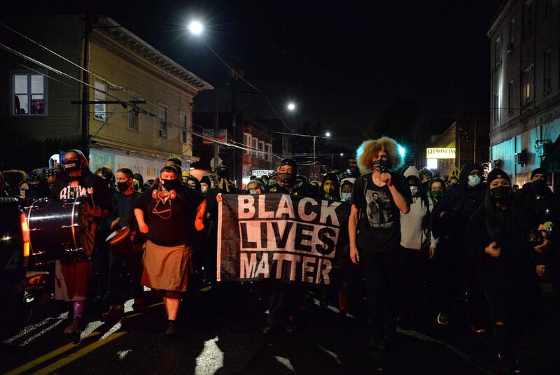Black Lives Matter protesters march through the streets of Portland, Oregon. President Donald Trump and Democratic challenger Joe Biden are battling it out for the White House, with polls closed across the United States Tuesday - and a long night of waiting for results in key battlegrounds on the cards. AFP