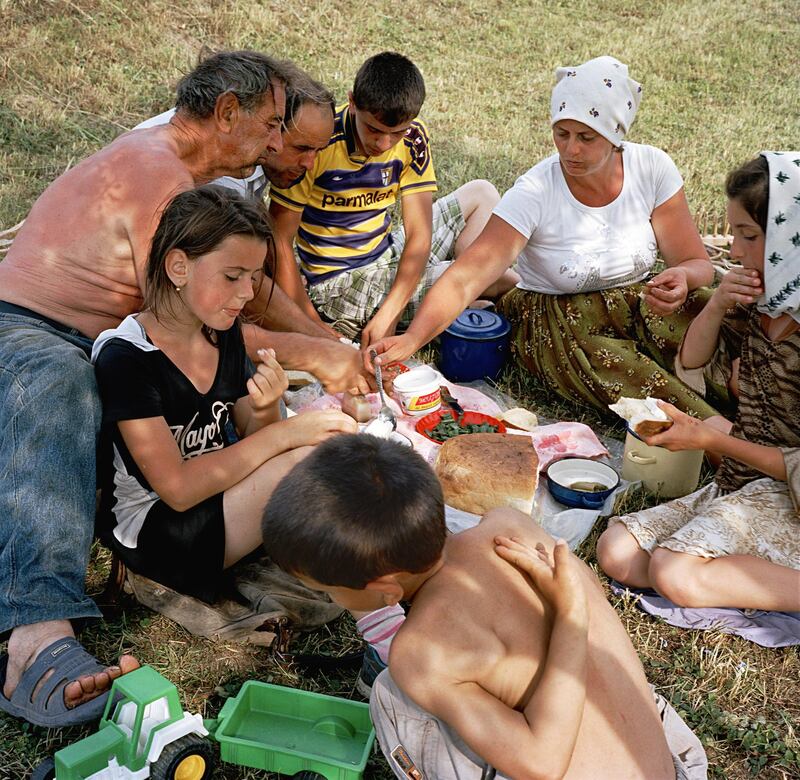 The Borca family relaxes after a working day that started early. Gheorghe (white shirt) and Anu?a Borca (also in white) were married in July 1995, bang in the middle of the grass-cutting season. The honeymoon had to be shortened. ÒWe started making hay again one week after the wedding,Ó Anu?a says ruefully. This photograph was made in Maramure?, the Romanian-speaking part of northern Transylvania. Romania. June, 2012