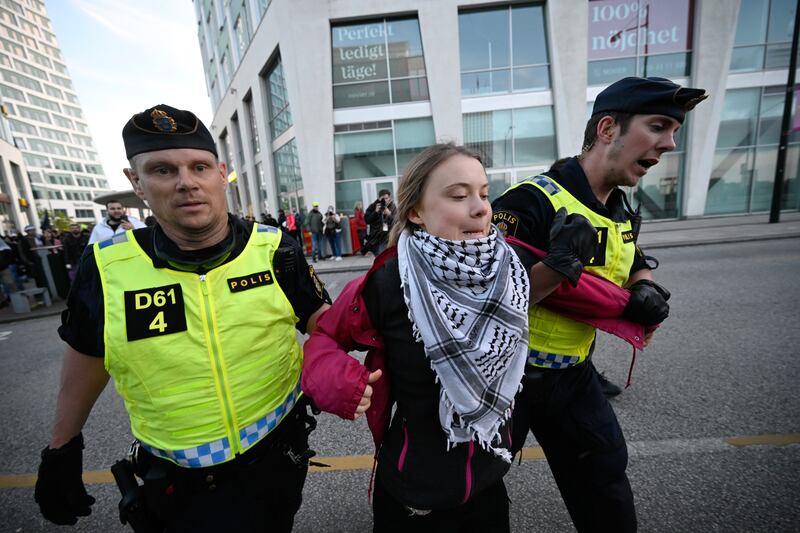 Swedish climate campaigner Greta Thunberg is removed by police from outside Malmo Arena during a pro-Palestine rally during the 68th Eurovision Song Contest in Malmo. EPA