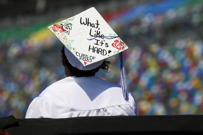 A student of Matanzas High School, which was closed due to the coronavirus disease (COVID-19) restrictions, waits to begin the graduation ceremony at Daytona International Speedway in Daytona Beach, Florida, U.S. May 31, 2020. REUTERS/Eve Edelheit