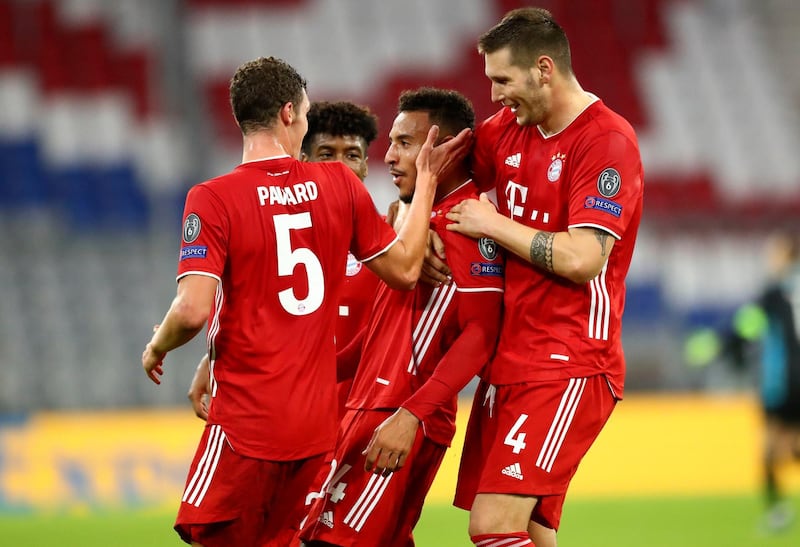 Bayern Munich's Corentin Tolisso, centre, celebrates with teammates after scoring his team's third goal. AP