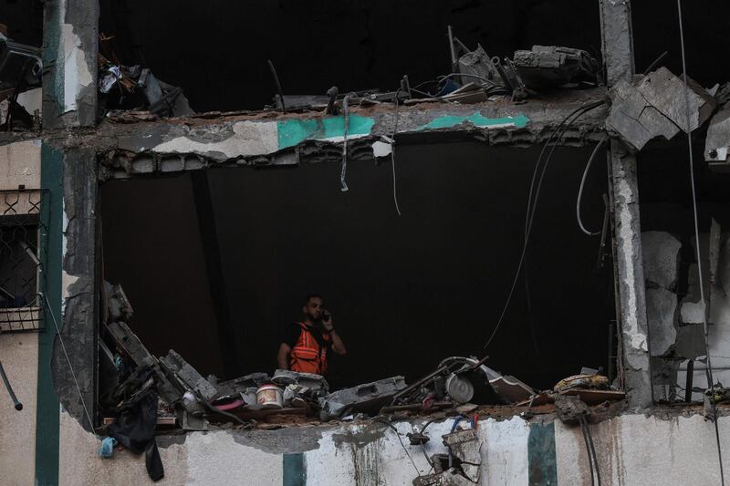 A Palestinian civil defence member checks the rubble of an apartment destroyed by Israeli air strikes in Gaza. AFP