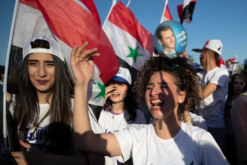 Holding flags and pictures of Syrian President Bashar Al Assad, supporters rally at Umayyad Square. Wednesday's poll is the second since Syria's civil war began in 2011. AP Photo