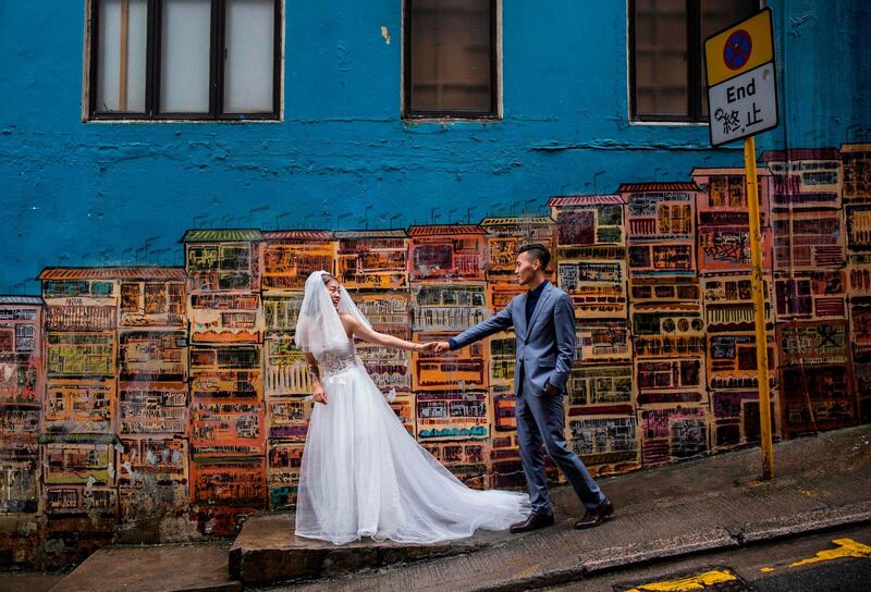 A couple pose for wedding photos in the central district of Hong Kong. AFP