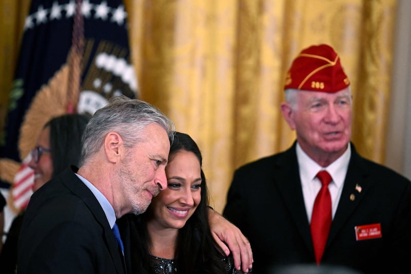 Stewart embraces Ms Robinson at the ceremony. AFP