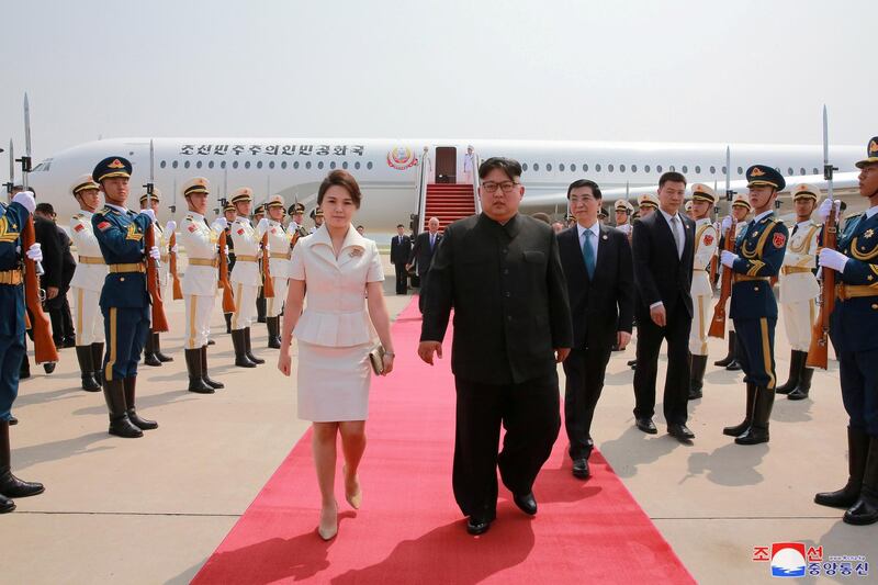 North Korean leader Kim Jong-un and his wife Ri Sol-ju arrive in Beijing, China. KCNA via Reuters