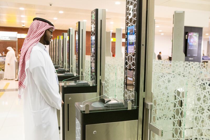 An airport employee stands in front of the newly implemented E-Border gate, part of the smart travel system, at the Abu Dhabi International Airport on April 13, 2016. Christopher Pike / The National