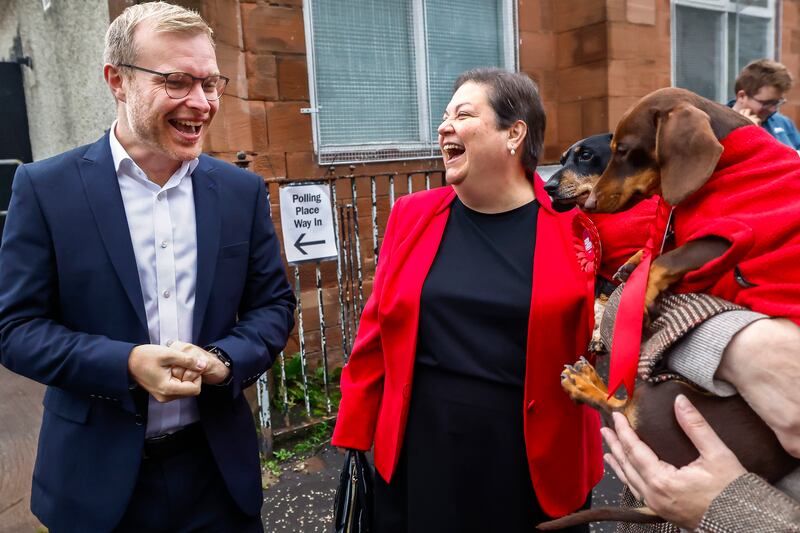 Allan and Stanley with Mr Shanks and Scottish Parliament member Dame Jackie Baillie at the polling station. Getty Images