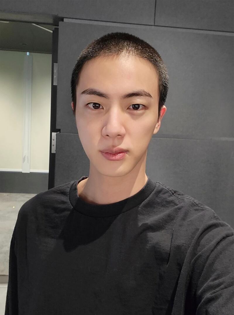 Jin sports a buzz cut before the start of his conscription. AP