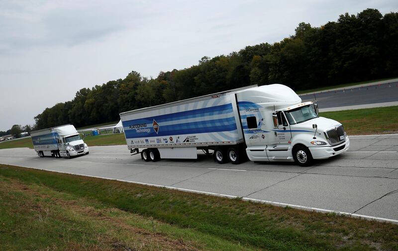 Two trucks demonstrate "platooning" technology at the Navistar Proving Grounds in New Carlisle, Indiana, U.S., October 12, 2016. REUTERS/Jim Young/FILE PHOTO