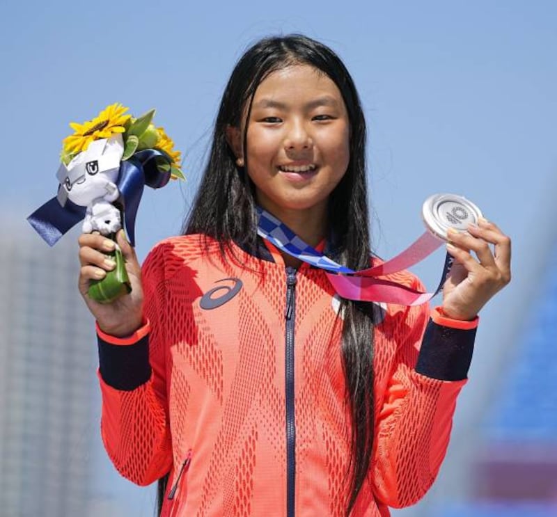 Kokona Hiraki, 12, of Japan poses with her silver medal in the women's park skateboarding at the Tokyo Olympics.