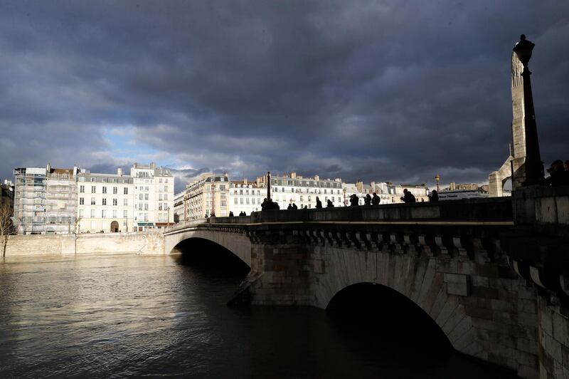 Floodwaters overflow the banks of the Seine river near Notre Dame in Paris. Etienne Laurent / EPA