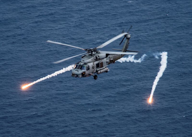 A US Navy MH-60R Sea Hawk helicopter from the "Blue Hawks" fires chaff flares during a training exercise near the aircraft carrier USS Carl Vinson. Reuters