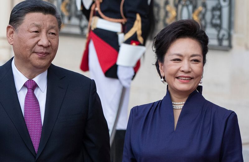 Chinese President Xi Jinping and his wife Peng Liyuan arrive for a state dinner at the Elysee Palace in Paris on Monday. EPA