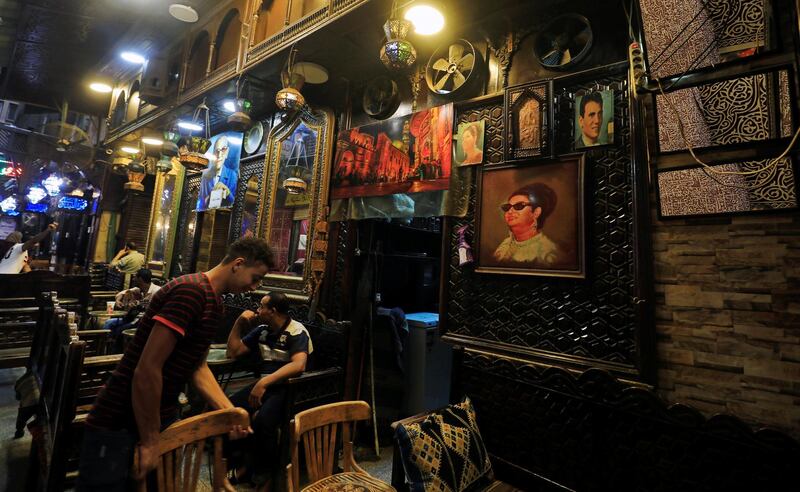 A man sits next to empty seats in a traditional cafe at the Khan el-Khalili market in Old Cairo, Egypt. Reuters