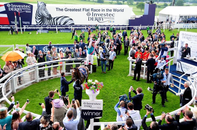 The large sign proclaiming the Epsom Derby as "The Greatest Flat Race in the World" looms large next to the racetrack. Pat Healy / racingfotos.com



