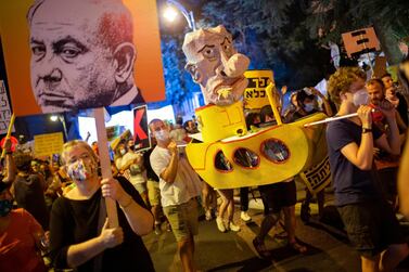 Demonstrators protest against Israel's Prime Minister Benjamin Netanyahu outside his residence in Jerusalem on Saturday. AP Photo