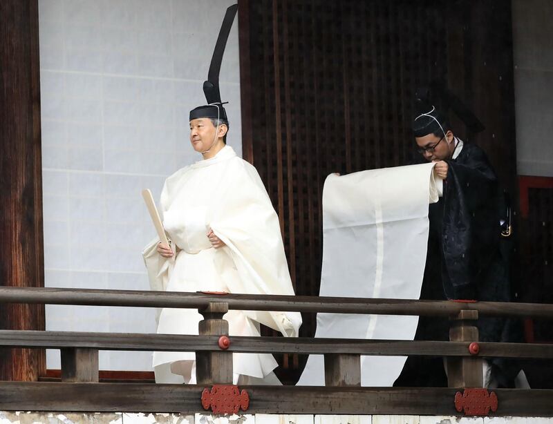 Japan's Emperor Naruhito walks to Kashikodokoro sanctuary to report the proclamation of his ascension to the throne during a ritual at the Imperial Palace in Tokyo on October 22, 2019. AFP