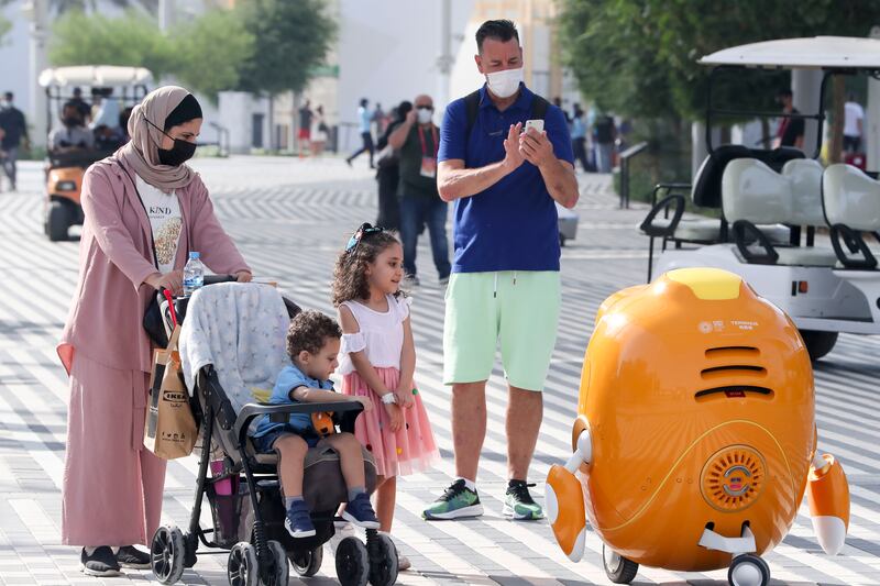 Opti the robot entertains families on the streets of Dubai. Khushnum Bhandari / The National