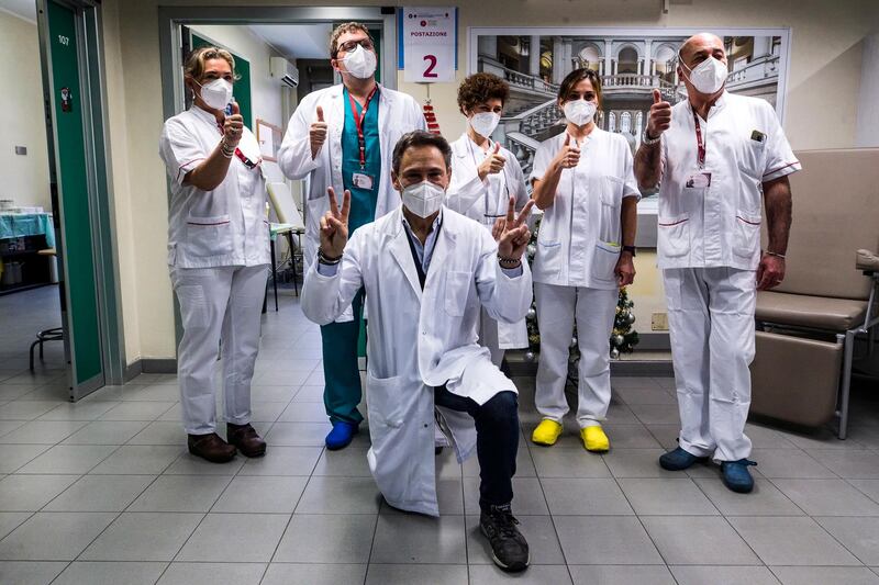 The first five vaccinated hospital staff and Health Director Alberto Deales pose for a photo as the Covid-19 vaccine is administered at the Umberto I Hospital in Rome, Italy. A vaccination campaign against Covid-19 started across the EU on 27 December.  EPA