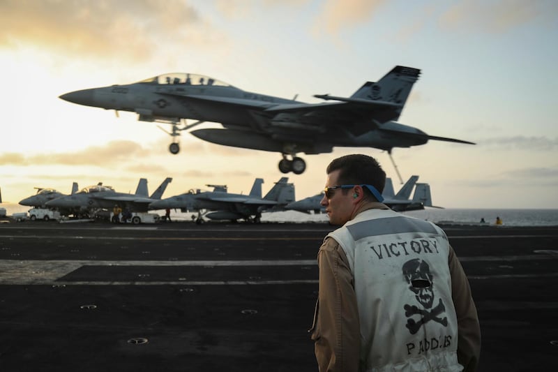 epa07632525 A handout photo made available by the US Navy shows US Lt. Nicholas Yerkes, from Annapolis, Maryland, a landing signals officer aboard the Nimitz-class aircraft carrier USS Abraham Lincoln (CVN 72), standing watch as an F/A-18F Super Hornet from the 'Jolly Rogers' of Strike Fighter Squadron (VFA) 103 land on the flight deck, in the Arabian Sea, 03 June 2019 (reissued 07 June 2019). The Abraham Lincoln Carrier Strike Group (CSG) 12 is deployed in the region amid heightened tensions between the US and Iran, with both saying they don't seek war.  EPA/US NAVY/MC 3RD CLASS JEFF SHERMAN HANDOUT  HANDOUT EDITORIAL USE ONLY/NO SALES