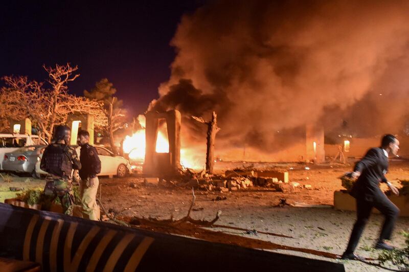 Police and a paramilitary soldier are seen after an explosion at a luxury hotel in Quetta, Pakistan. Reuters