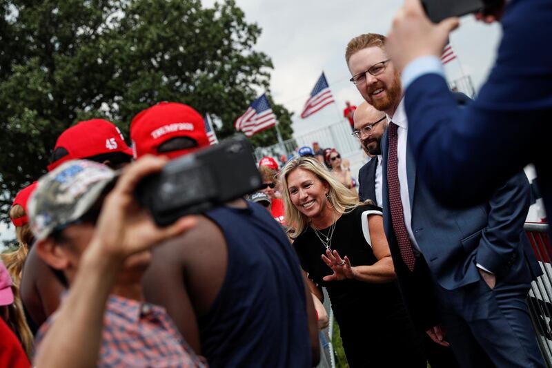 Marjorie Taylor Greene, a Republican senator, with supporters of former US president Donald Trump as they gather for his first post-presidency rally in Wellington, Ohio. Reuters