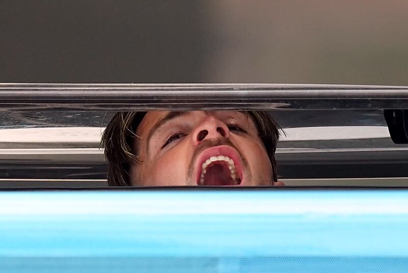Manchester City's Jack Grealish pokes his head out of the skylight as their coach leaves the team hotel in Istanbul, following their victory over Inter Milan in yesterday's UEFA Champions League Final. PA