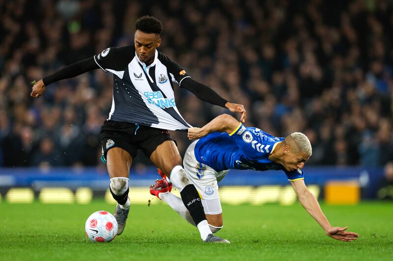 Newcastle's Joe Willock has his shirt pulled by Everton attacker Richarlison. PA