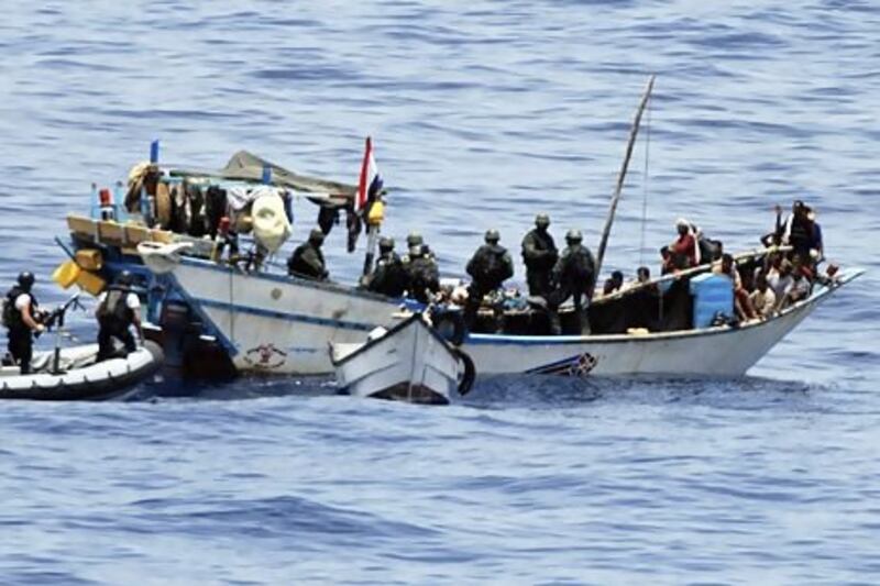 Dutch marines board a Yemeni fishing boat in the Gulf of Aden. The boat had been captured by Somali pirates. AP